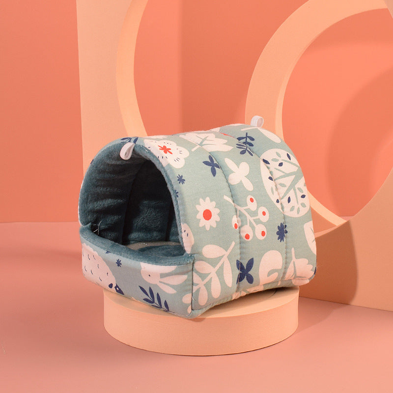 Cozy hamster nest in soft cotton with floral design, perfect for small pets, shown in a stylish setting.